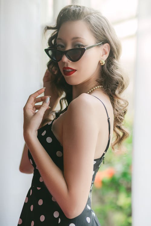 Portrait of a Beautiful Brunette Wearing Sunglasses and a Polka Dot Dress