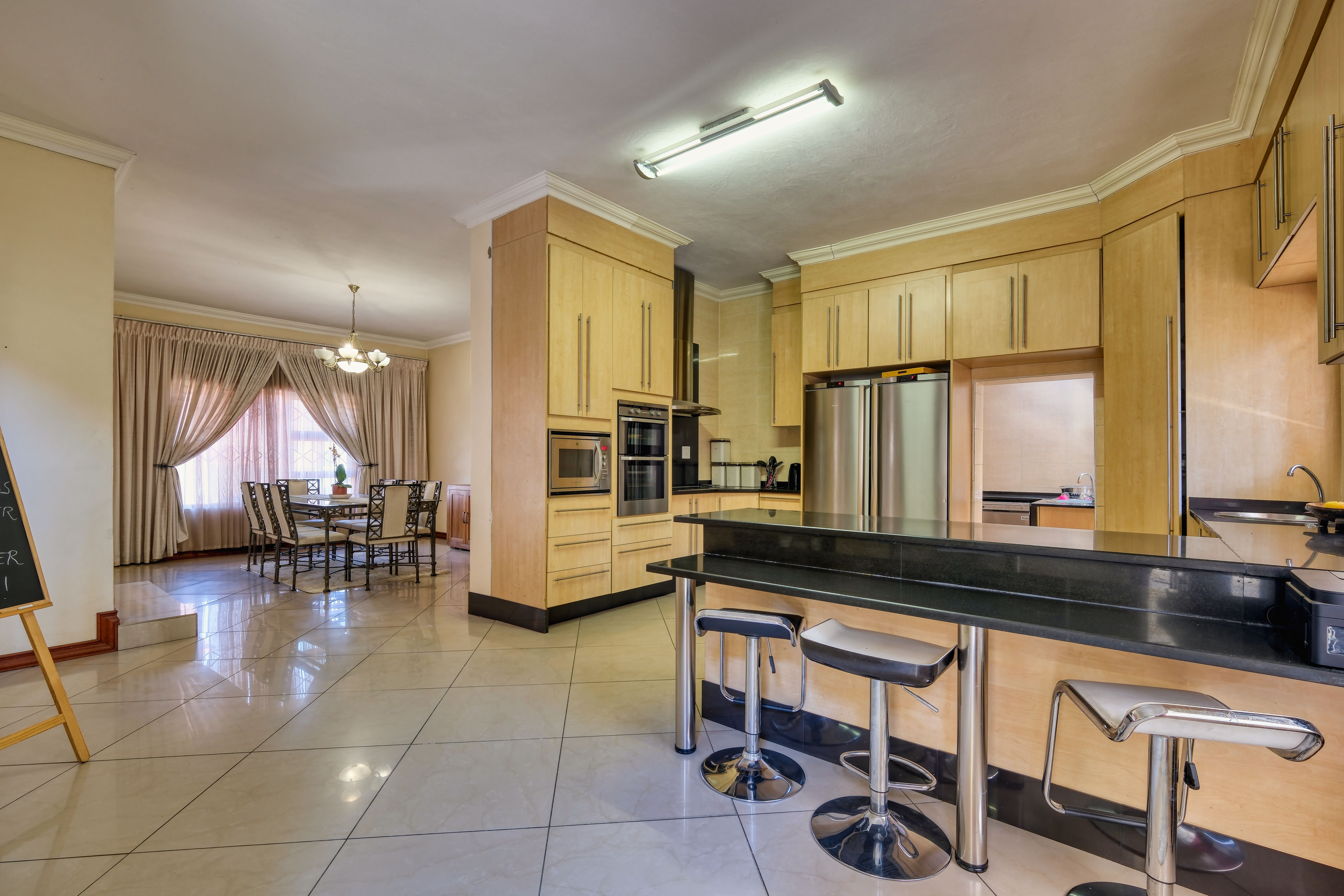 Kitchen and a Dining Room in a Spacious Modern Apartment · Free Stock Photo