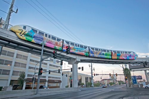 Free Vibrant Las Vegas monorail captured above city streets, showcasing urban transit charm. Stock Photo