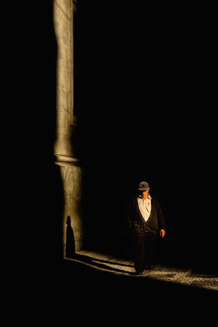 Faceless Senior Man Walking Along Dark Cemetery