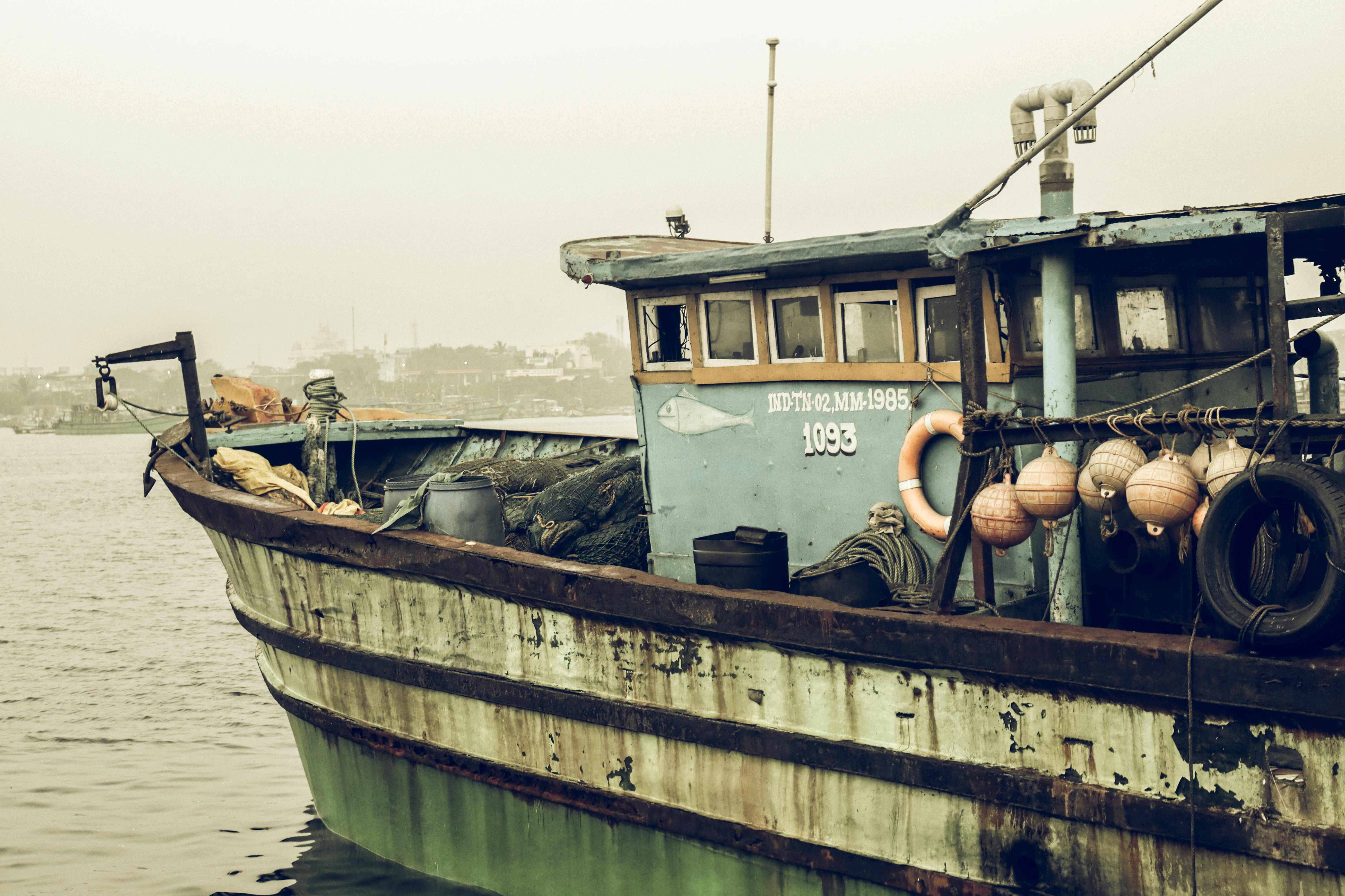 Sunken Fishing Boat Moored on Sea Coast · Free Stock Photo