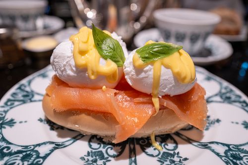 Free Close-up of smoked salmon eggs benedict with hollandaise sauce on a decorative plate. Stock Photo