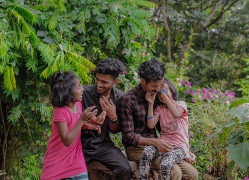 Smiling Men Sitting with Girls