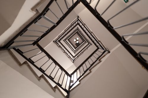 Free Abstract view of a spiraling staircase with geometric patterns and clean lines. Stock Photo