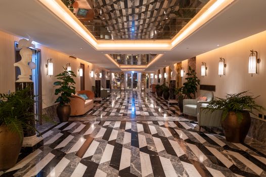Elegant hotel lobby featuring luxurious marble flooring and stylish furnishings.