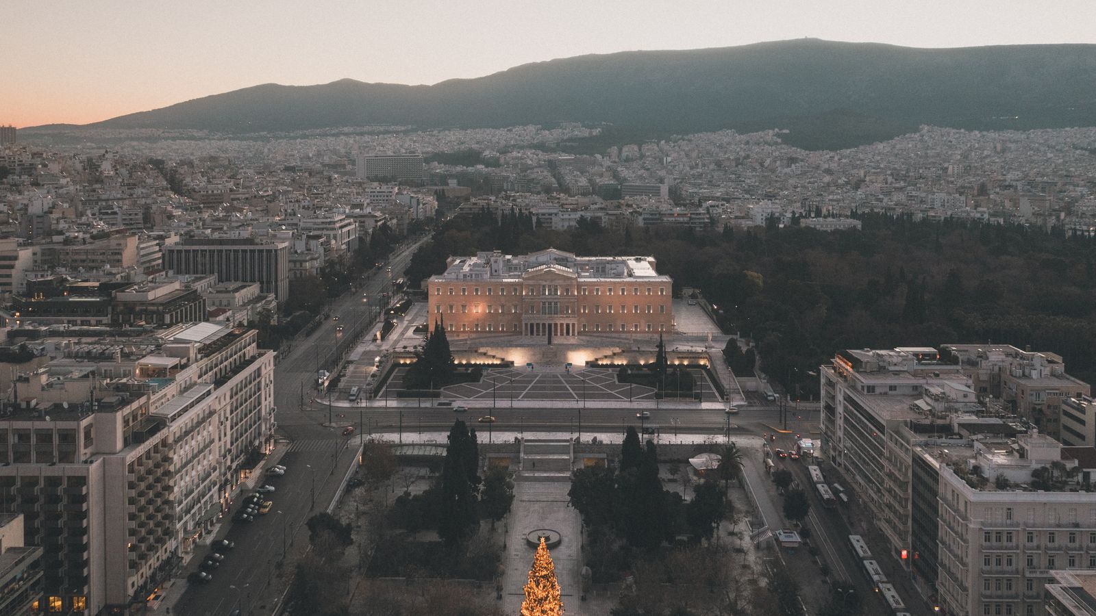 Scenic aerial view of Syntagma Square, Athens, Greece, illuminated at dusk with a Christmas tree.