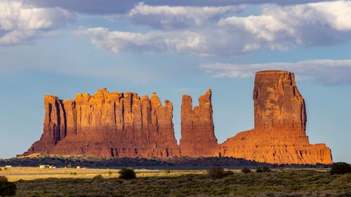 Free Breathtaking view of Monument Valley's iconic red rock formations under a vivid blue sky. Stock Photo