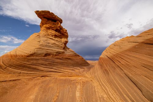 Free A stunning eroded rock formation with vibrant layers under a dramatic sky, highlighting nature's artistry. Stock Photo