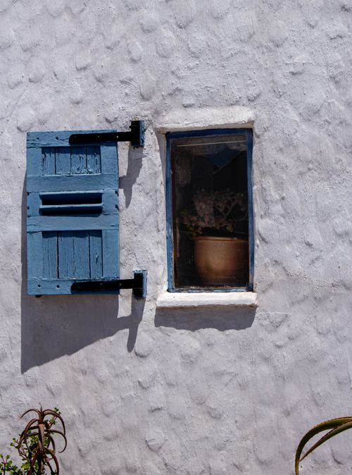 Free Charming blue shutter on a rustic white wall in Paternoster, South Africa, under bright sunlight. Stock Photo