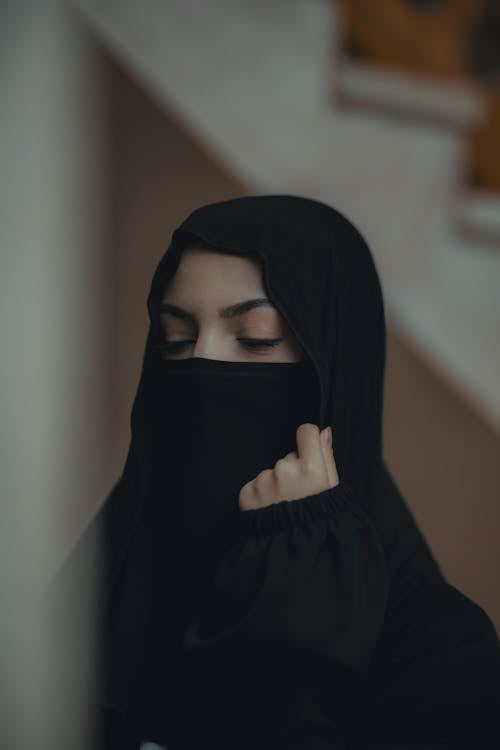 Woman Wearing a Black Hijab Standing with Eyes Closed