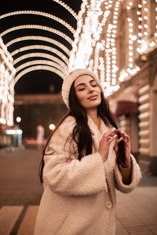 Brunette Woman in Coat at Night