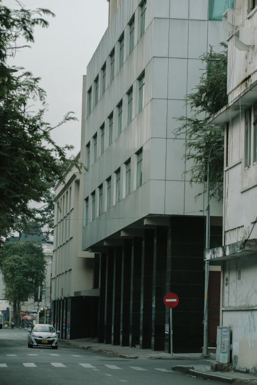 Free A street view of urban architecture featuring modern facades and city elements. Stock Photo