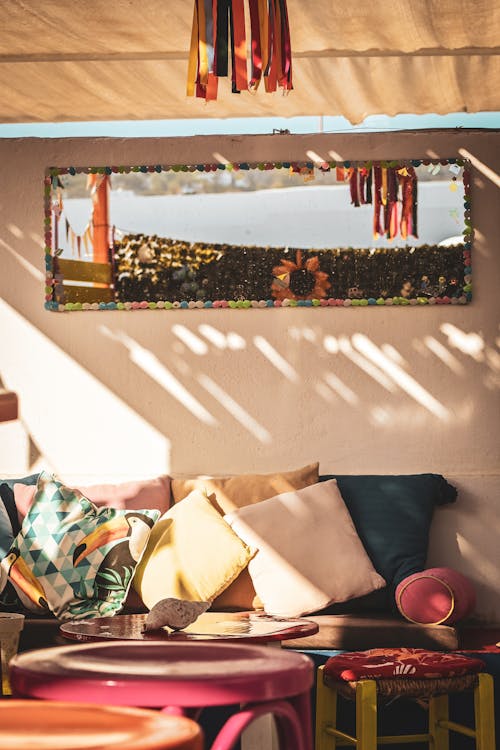 A Sofa with Pillows and Tables in a Patio 