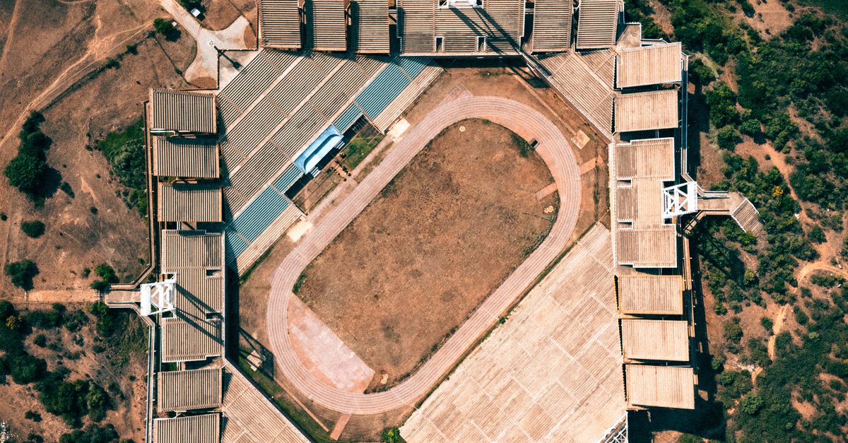 aerial view of Christ Embassy Loveworld Arena in Ho Volta Region with people arriving