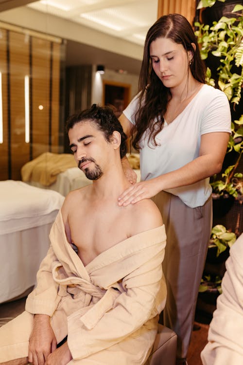 A Woman Giving a Massage to a Man
