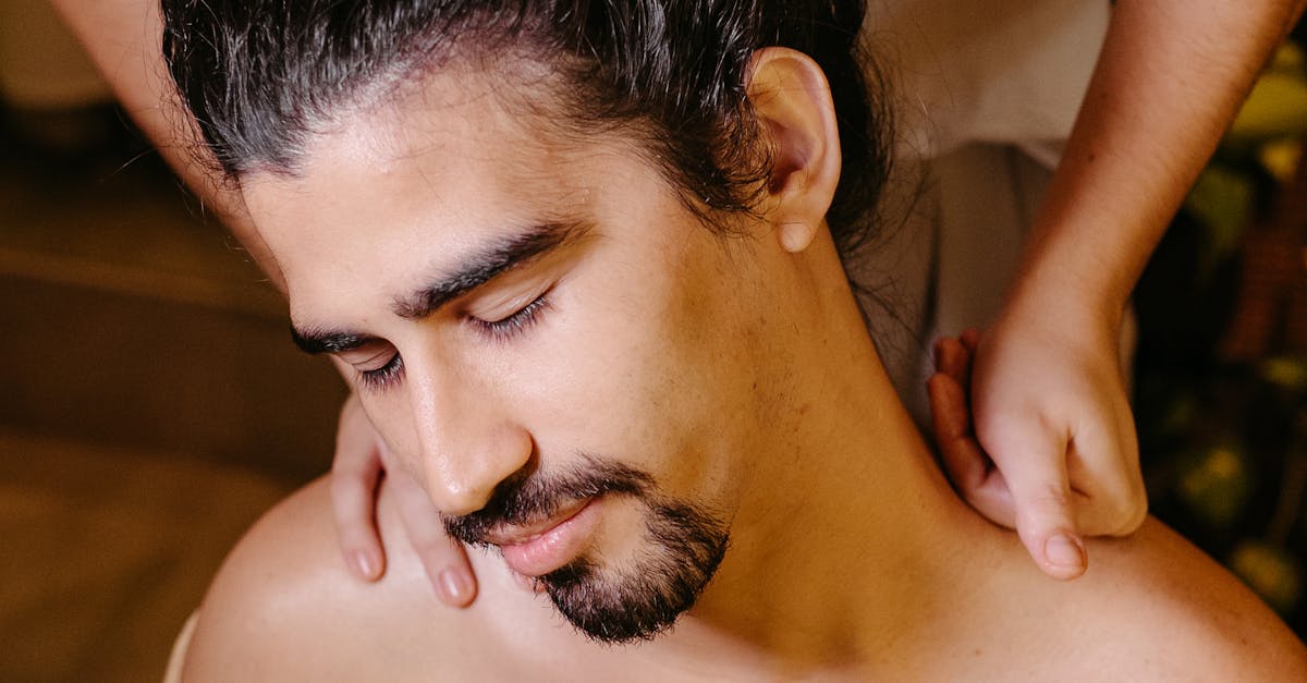 A masseuse performing a deep tissue massage on a client's back.