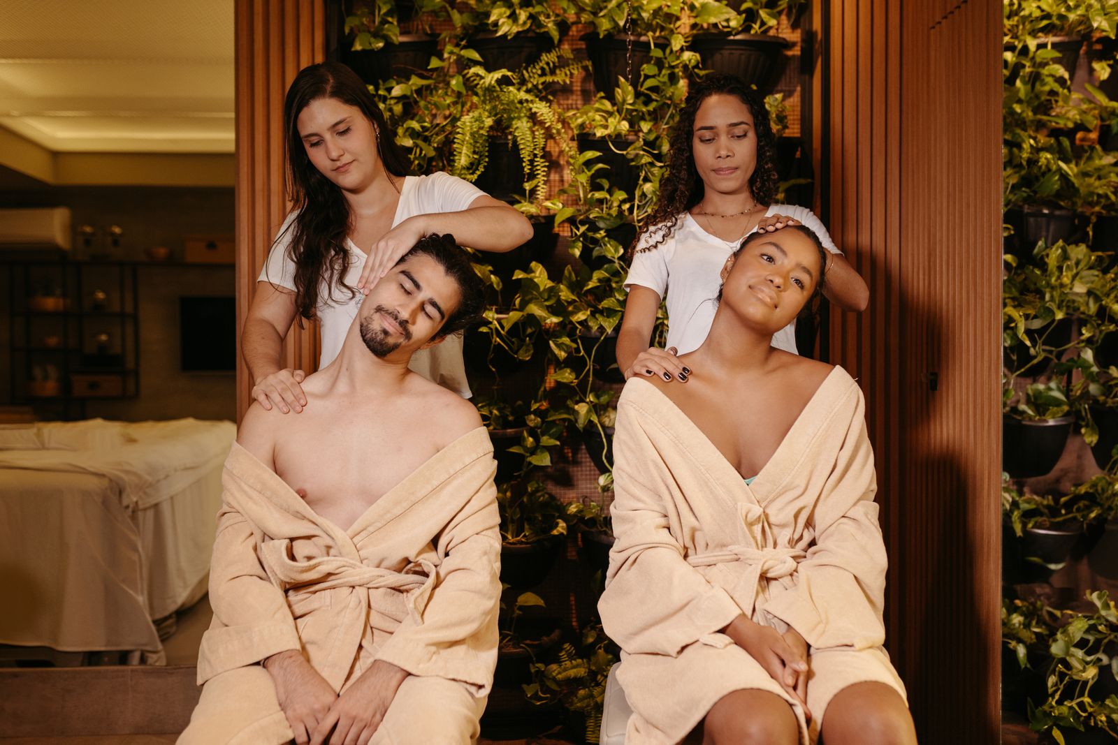 Two guests in robes relaxing in a garden