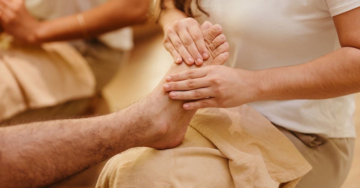 A person receiving reflexology foot massage at a spa.
