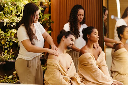 Women Massaging Clients at Spa