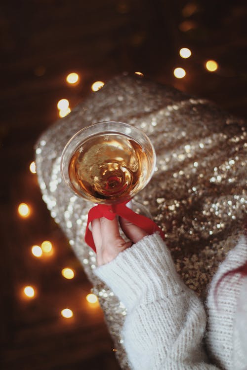 Woman in Glistening Dress With Champagne Glass