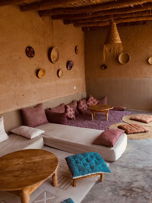 A warm, rustic living room featuring woven baskets and cushioned seating.