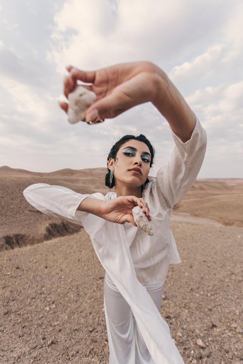 Young Woman in a White Shirt Holding Rocks