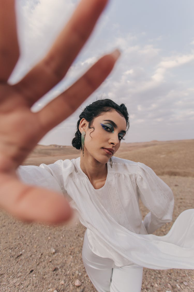 Young Woman In A White Shirt Showing Her Hand