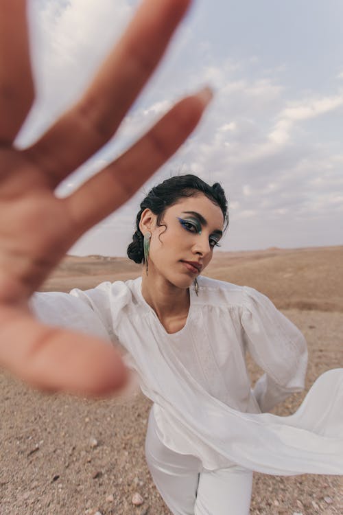 Free Young Woman in a White Shirt Showing Her Hand Stock Photo