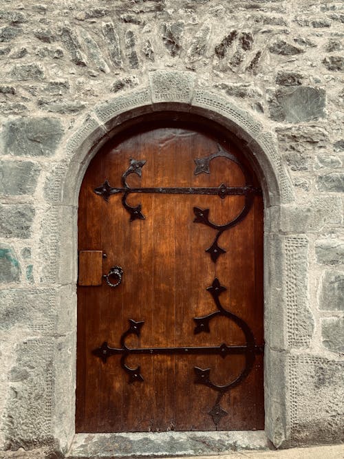 Old Wooden Arch Doors in a Stone Wall 