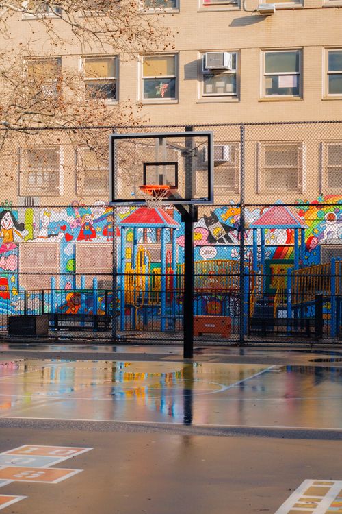 Free Vibrant city playground featuring basketball court and artistic mural, showcasing urban culture. Stock Photo