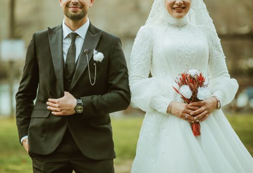 Free Elegant couple in classic wedding attire, smiling on their special day. Stock Photo