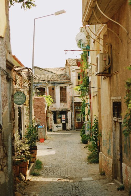 Free Explore a picturesque narrow alley with cobblestone street and vintage architecture in a quaint village. Stock Photo