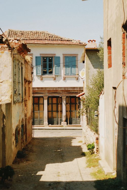 Free Explore the timeless charm of a rustic Mediterranean alley, bathed in warm sunlight. Stock Photo