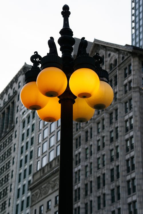 A Lantern on the Street in City on the Background of a Tall Building 