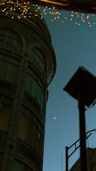 Low angle view of a historic building and crescent moon at dusk in Ciudad de México, adding urban charm.