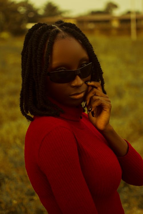 Free Portrait of a fashionable black woman wearing sunglasses and red top, outdoors in Keffi, Nigeria. Stock Photo