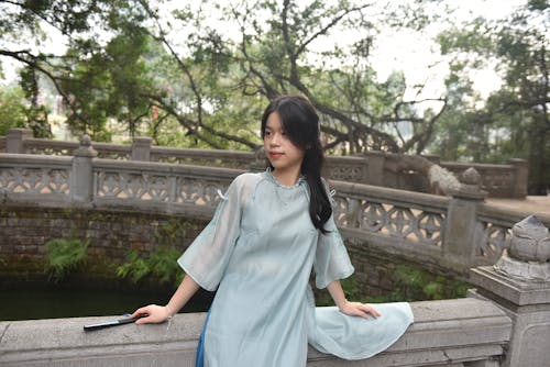 Brunette Posing with Fan, Wearing Traditional Clothing