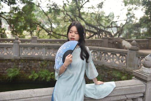 Young Woman with a Blue Floral Fan