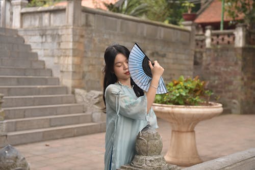 Model in a Blue Ao Dai Tunic with Embroidered Sleeves