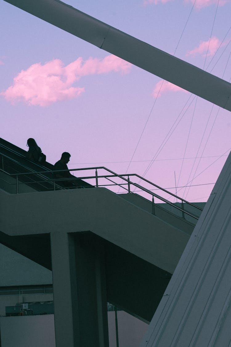 Silhouette Of People Sitting On Stairs During Sunset 