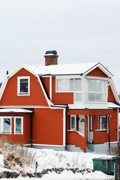 Free A picturesque red house covered in snow in Jönköping, Sweden, showcasing classic Scandinavian architecture. Stock Photo