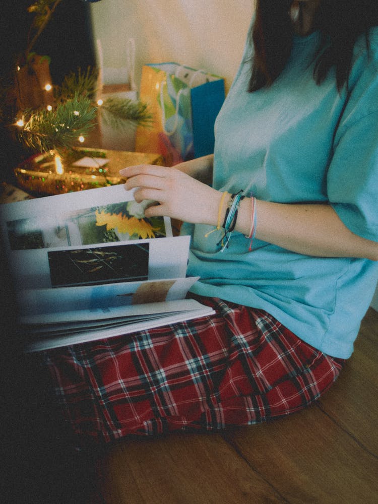 Woman With Book By Christmas Tree