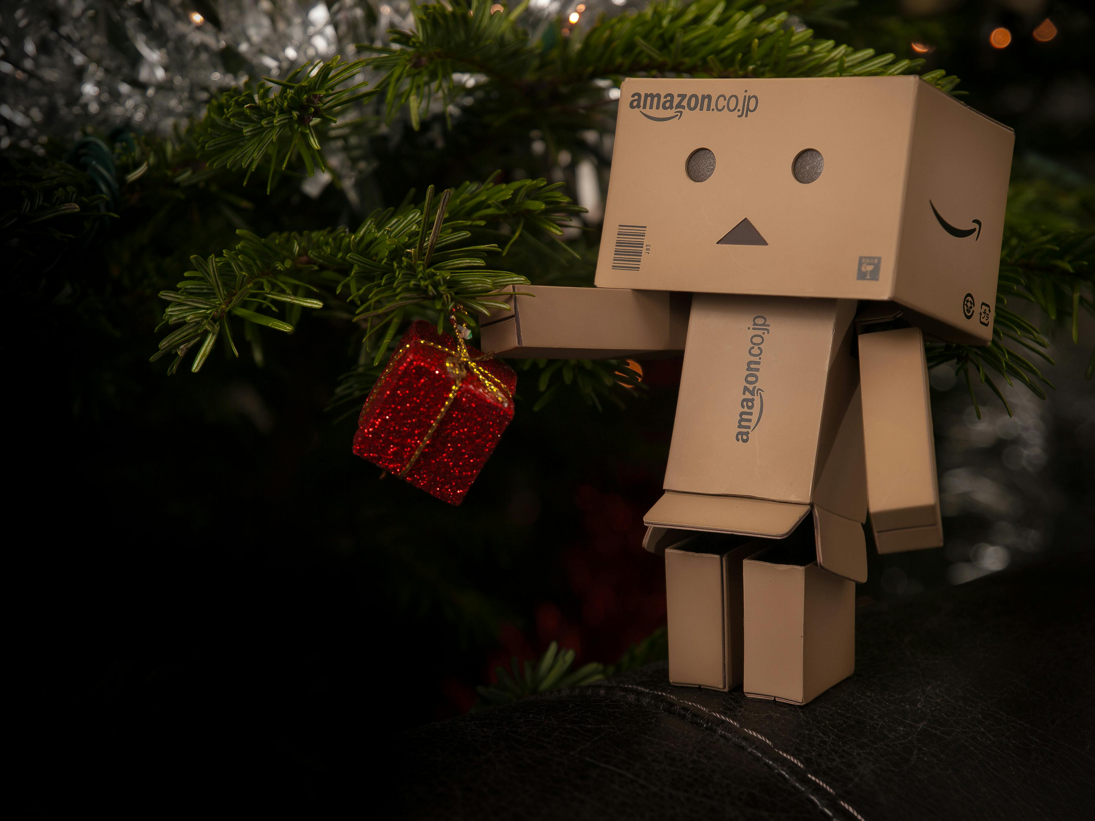 amazon cardboard figurine near christmas tree