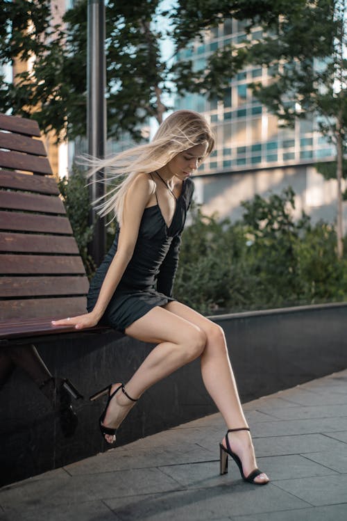 Gorgeous Blonde Woman in Black Dress Posing in Park