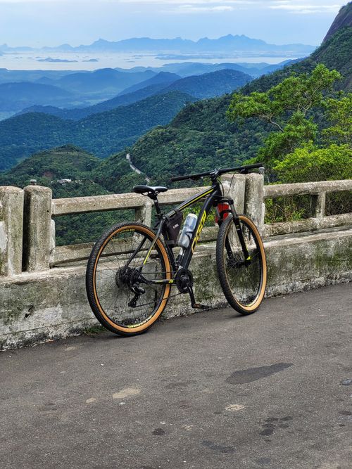 Free A parked bicycle overlooking a stunning mountain landscape, perfect for adventure travel enthusiasts. Stock Photo