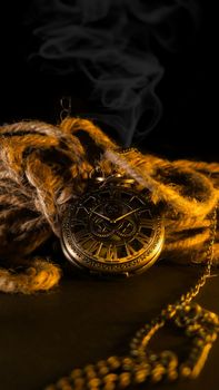 Intricate vintage pocket watch entwined in rustic rope, evoking nostalgia and timeless elegance.