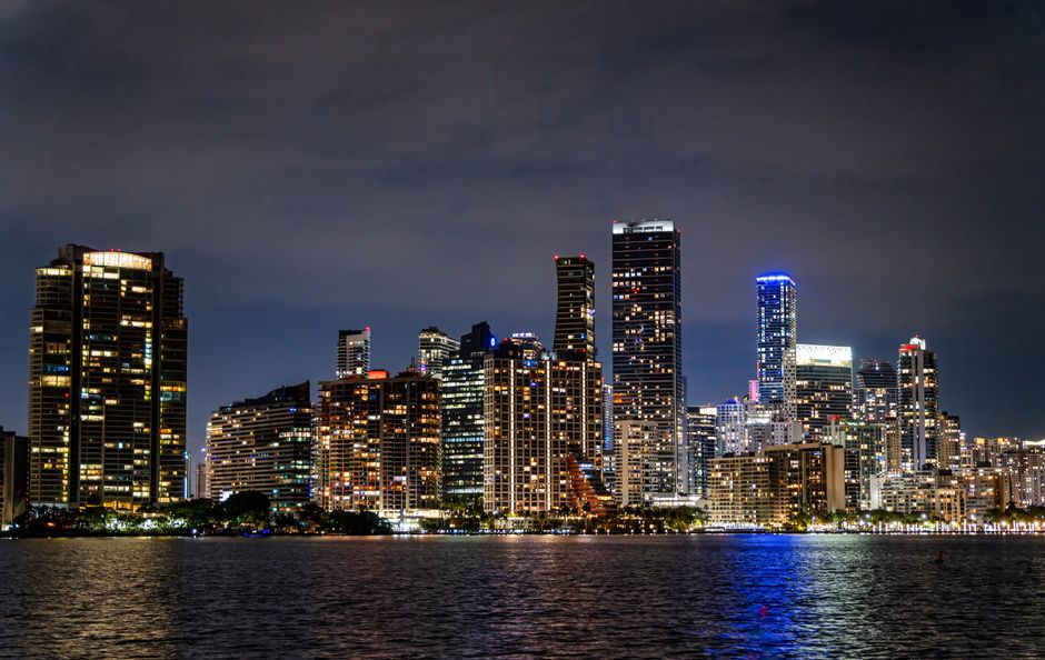 Captivating view of Miami's illuminated skyline at night, showcasing its modern architecture and vibrant city life.