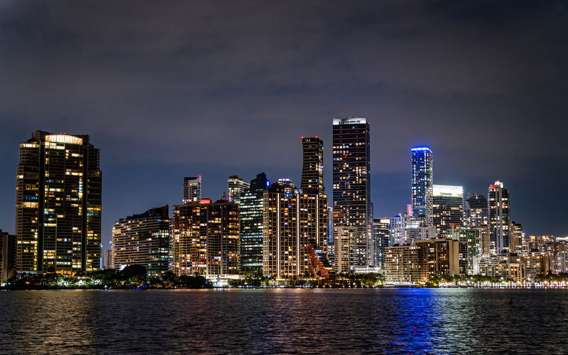 Captivating view of Miami's illuminated skyline at night, showcasing its modern architecture and vibrant city life.