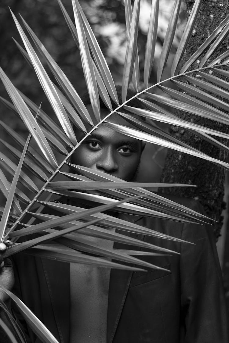 Man Among Tropical Leaves In Black And White 