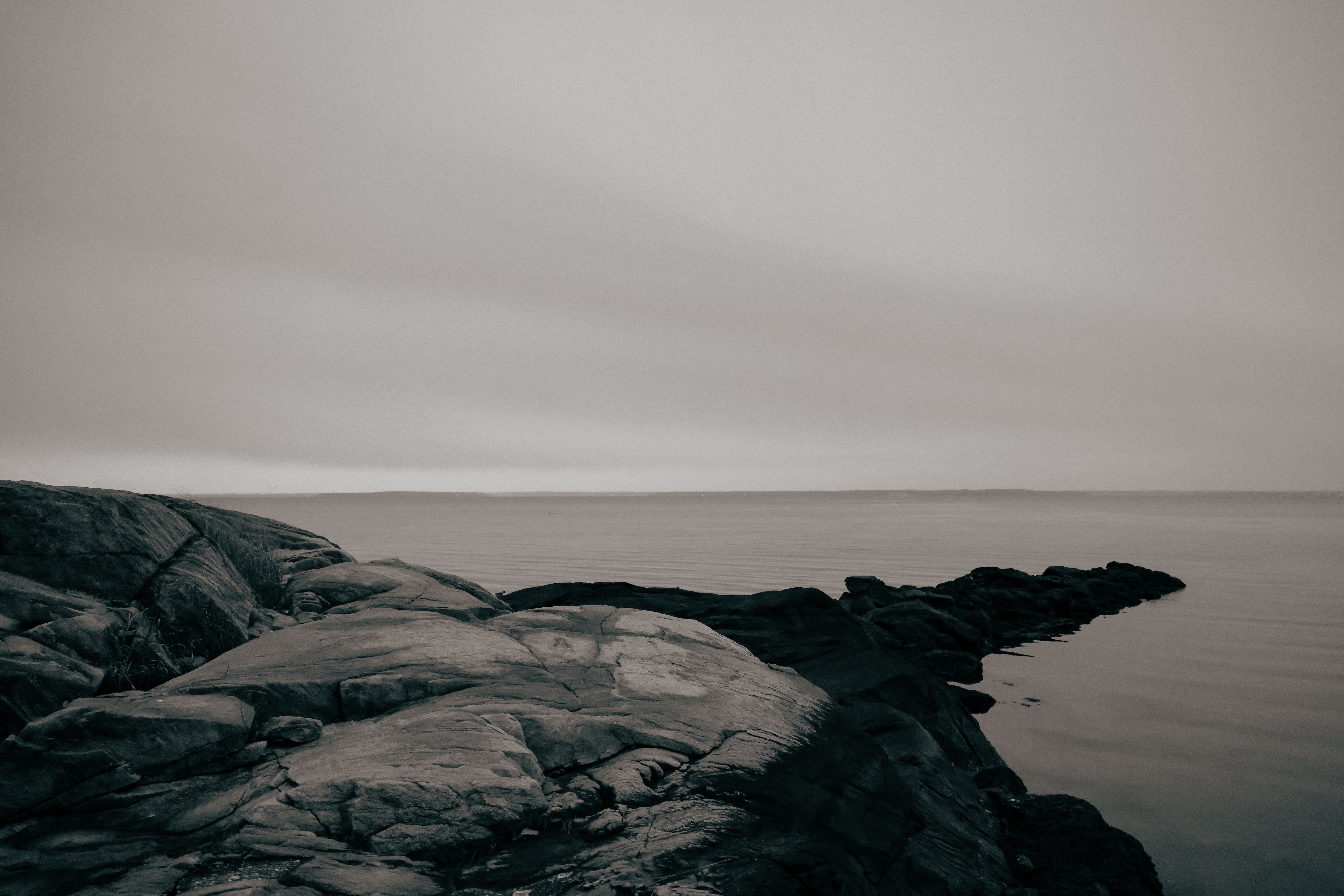 Black and White Photo of a Rocky Shore · Free Stock Photo